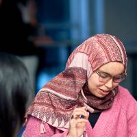 International Anchor Allies Winter 2026 First Mixer - female student focused on a bingo game